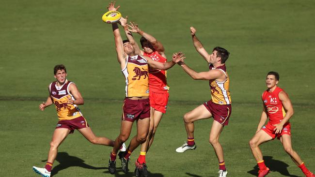 Connor Ballenden of the Lions and Chris Burgess of the Suns compete for the ball during an AFL pre-season match on the Gold Coast. Picture: Getty Images