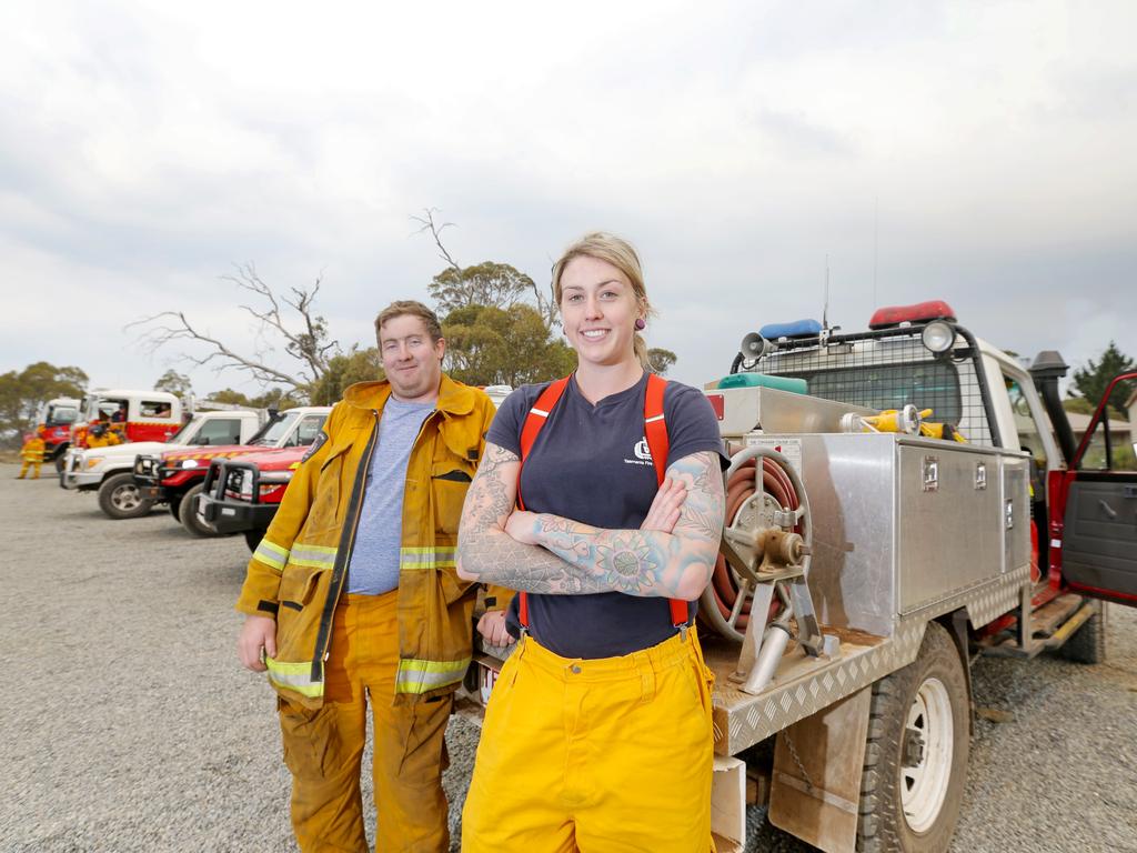 Volunteer fire fighters Tara Felts, from Claude Road Fire Brigade, and Jackson Marshall, from Sheffield Fire Station, getting a well-earned break after battling fires in the region overnight. Picture: PATRICK GEE