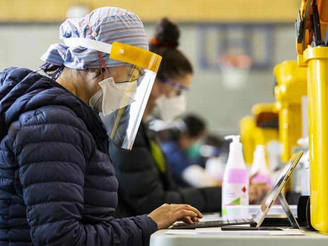 MELBOURNE, AUSTRALIA - NewsWire Photos October 15, 2021:  Health staff are seen inside a pop-up COVID vaccination hub at Casey Fields in Cranbourne, Melbourne, Victoria. Picture: NCA NewsWire / Daniel Pockett