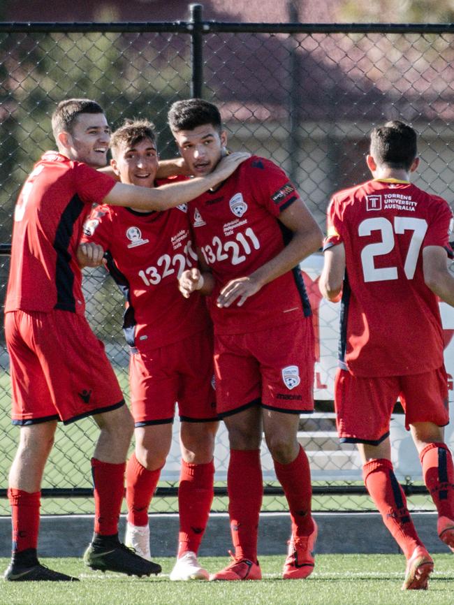 Adelaide United teammates celebrate a goal during their 3-2 win. Picture: AAP Image/ Morgan Sette