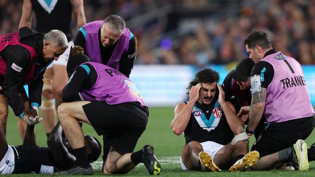 Aliir Aliir and Lachie Jones in the immediate aftermath of the incident. Picture: Sarah Reed/AFL Photos