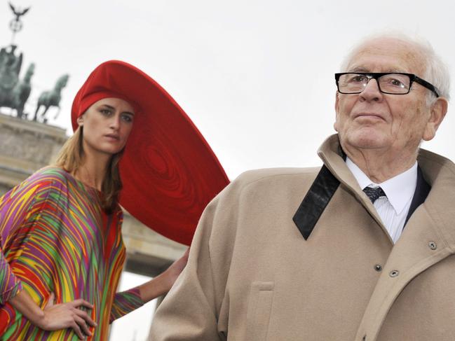 Cardin is pictured here in 2008 in front of Berlin's landmark Brandenburg Gate, alongside a model wearing his designs. Picture: AFP/Clemens Bilan.