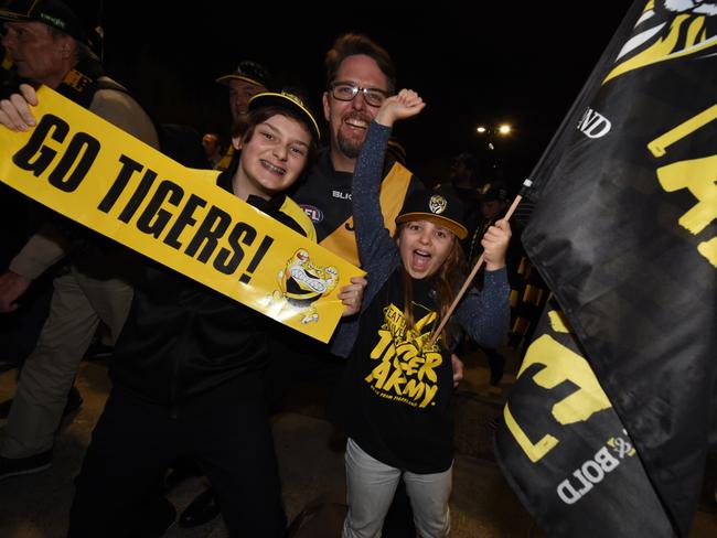 Richmond fans celebrate while leaving the MCG. Picture: Tony Gough