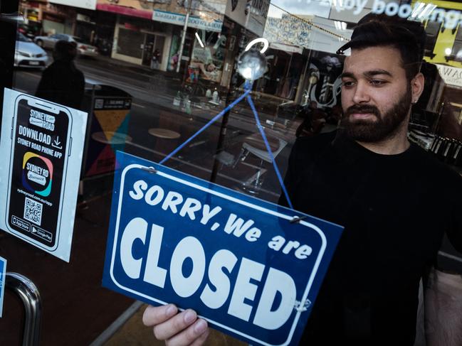 MELBOURNE, AUSTRALIA - AUGUST 05: Mas Azemi of Mas Barber Shop closes his shop on August 05, 2020 in Melbourne, Australia. Mas is the owner of Mas Barber Shop in Brunswick.  He has had to close the shop for 6 weeks and stand down 4 barbers. Retail stores across Melbourne will be closed to customers from 11:59 pm on Wednesday 5 August as further stage 4 lockdown restrictions are implemented in response to Victoria's ongoing COVID-19 outbreak.  The majority of retail businesses like clothing, furniture, electrical and department stores will be closed to the public for the duration of the stage 4 restrictions. Businesses will be able to operate click and collect services with social distancing and contactless payments. Supermarkets, grocery stores, bottle shops, pharmacies, petrol stations, banks, news agencies and post offices will remain open during the lockdown. Melbourne residents are subject to a curfew from 8pm to 5am, must stay within a 5km radius of their homes along with limits on hours of exercise, while all students have returned to home learning and childcare centres have closed. (Photo by Darrian Traynor/Getty Images)