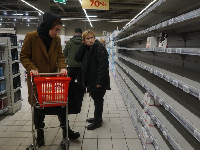 MOSCOW, RUSSIA - MARCH 16 (RUSSIA OUT): People look at empty shelves in the sanitary napkin section at a shopping mall on March 16, 2022, in Moscow, Russia. Many worldwide brands have suspended any investment and sales in Russia over its military invasion on Ukraine. (Photo by Konstantin Zavrazhin/Getty Images)