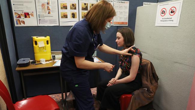 Student Holly Horne, 16, in year 11 at Elizabeth College is given her first Pfizer vaccination by Anne-Maree Kroon authorised nurse immuniser. Picture: Nikki Davis-Jones