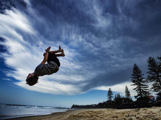 13 year old Tyler Humphries practicing his backflips under a storefront approaching over Moffat Beach at Caloundra. Photo Lachie MillardContact Dad Alan Humphries 0415380774