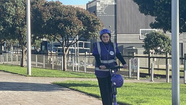 Beam foot marshall Sarah Sunderland riding an e-scooter in Burnie