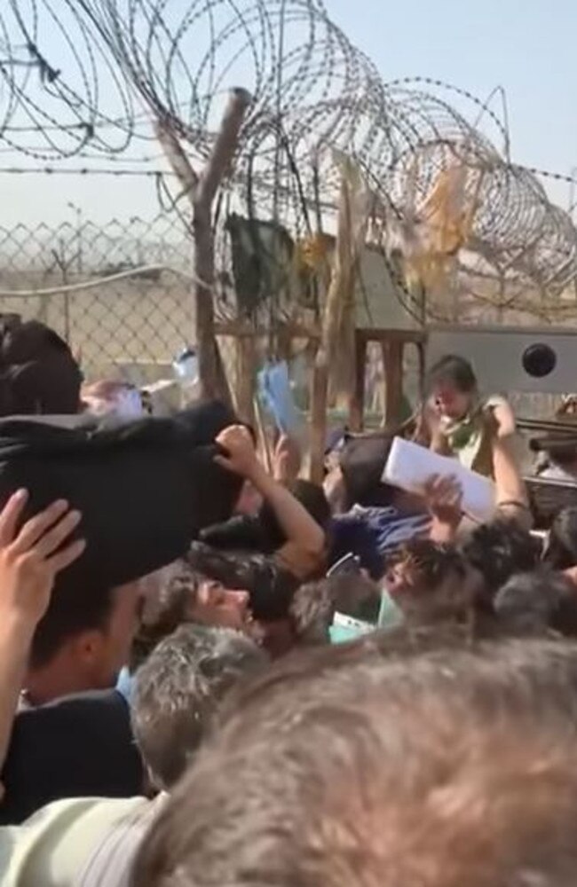 A baby being handed over the wall in Kabul at the International Airport. Picture: Instagram/ Rustam Wahab