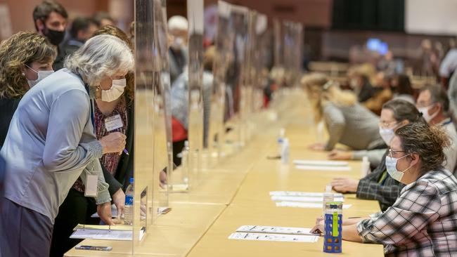 A representative for Donald Trump, left, looks over ballots during the presidential recount vote in Madison, Wisconsin. Picture: Getty Images/AFP