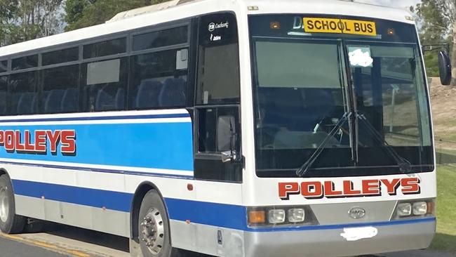 A Polleys Bus waiting outside James Nash State High School to pick up students.