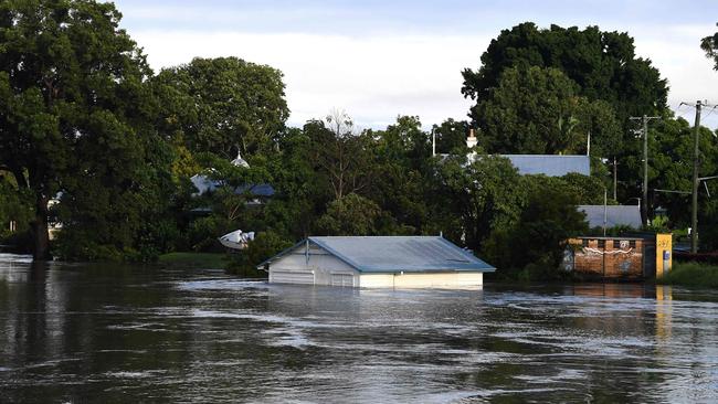 A submerged shed is seen on the bank of over flowing Clarence River in Grafton. Photo: SAEED KHAN / AFP
