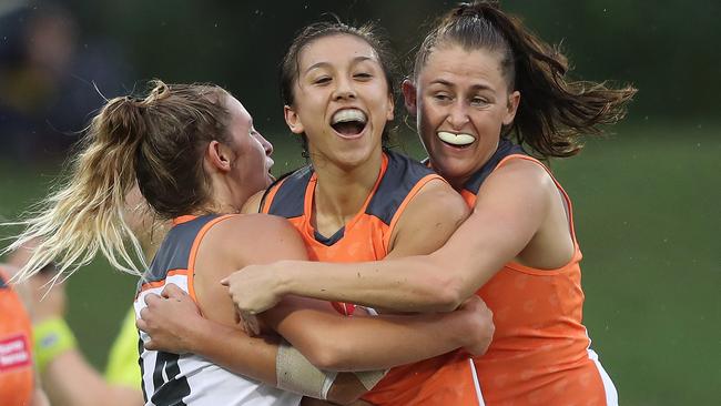 Rebecca Beeson (centre) celebrates a goal during the Giants’ historic first win. Picture: Phil Hillyard