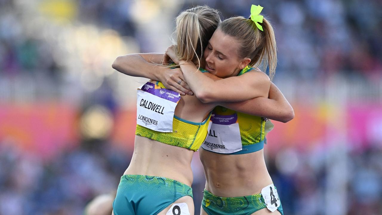 Australia's Linden Hall (R) congratulates teammate Australia's Abbey Caldwell on finishing third to take a bronze medal in the women's 1500m final athletics event at the Alexander Stadium, in Birmingham on day ten of the Commonwealth Games in Birmingham, central England, on August 7, 2022. (Photo by Glyn KIRK / AFP)