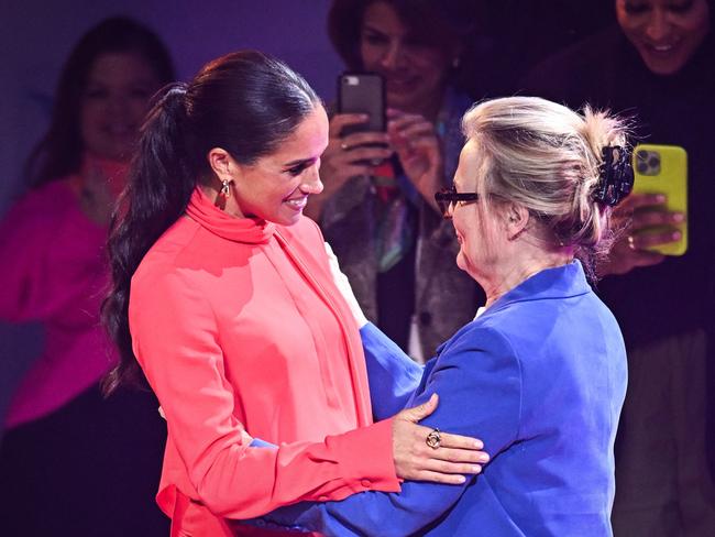 The Duchess of Sussex is welcomed by co-Founder of One Young World Kate Robertson. Picture: AFP