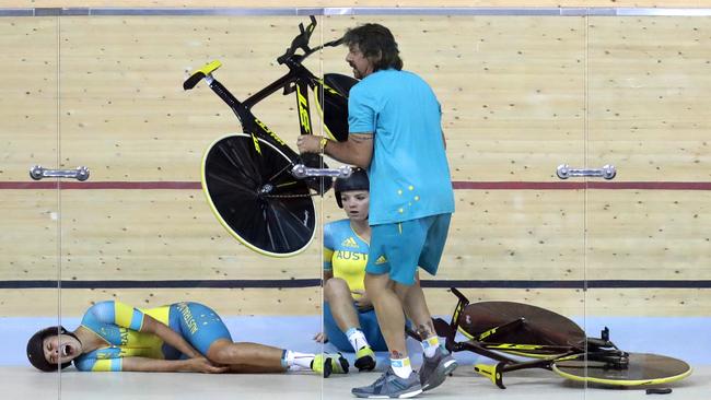 Tasmanian Amy Cure looks on after the crash involving teammate Melissa Hoskins, left, during a training session at the Rio Olympic velodrome. Picture: AP/Patrick Semansky