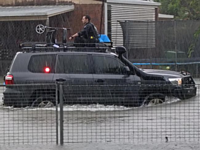 Queensland police officers rescued an elderly resident and their wheelie walker in a police four wheel drive after heavy rain caused flooding in Campbell Street, Klarwein Close and Whittaker Close in Gordonvale. Picture: Jade Fourmile