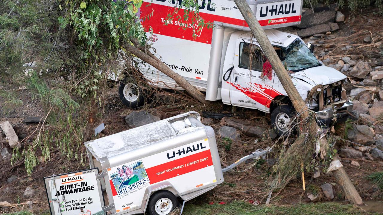 A damaged U-haul truck and trailer are seen sitting on the side of a hill in Asheville. Picture: Sean Rayford/Getty Images/AFP