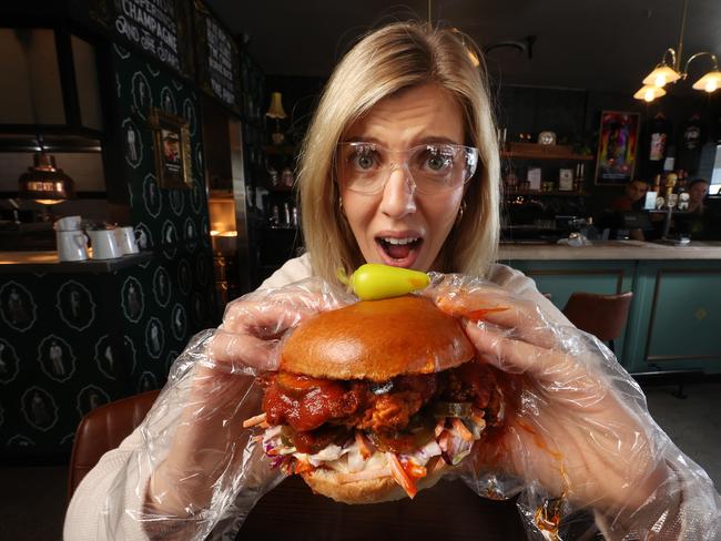 Chrysa Christopher, 25 of Mansfield, with the Nashville Death Wish, Australia’s hottest burger featuring Aged Moruga Scorpion chilli, Burger Urge Newmarket. Picture: Liam Kidston