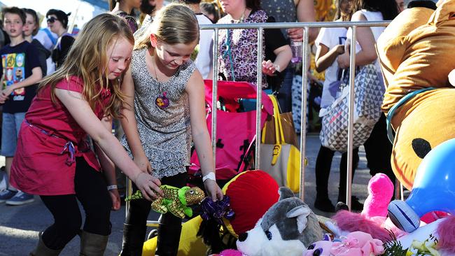 Children leave tributes at the impromptu memorial that sprung up where Adelene Leong was killed, after she was flung from a Royal Adelaide Show ride in 2014. Pic: Mark Brake