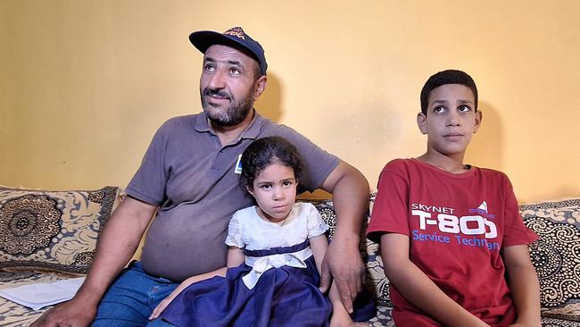 Omar Khelif, the father of Algerian boxer Imane Khelif, sits accompanied by his two young children in the family home in the province of Tiaret. Picture: AFP