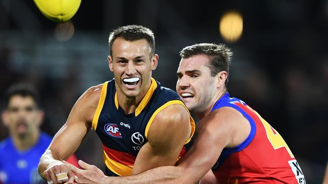 Tom Doedee gets a handball away under pressure against the Lions. Picture: Mark Brake/Getty Images