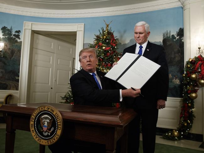 President Donald Trump, accompanied by Vice President Mike Pence, holds up a signed proclamation recognising Jerusalem as the capital of Israel. Picture: AP Photo/Evan Vucci