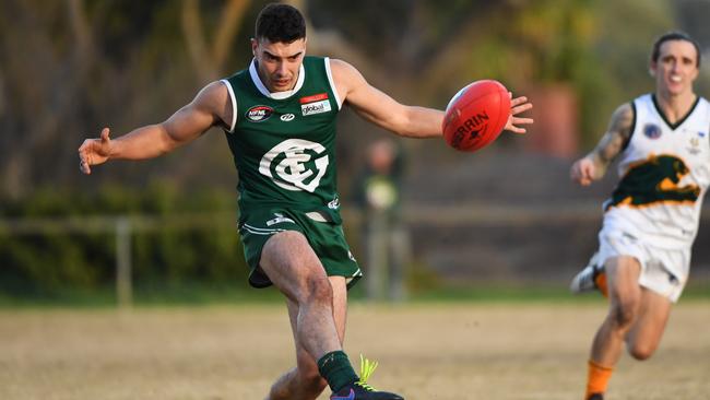 Greensborough’s Lachlan Hill gets a kick away earlier this season.