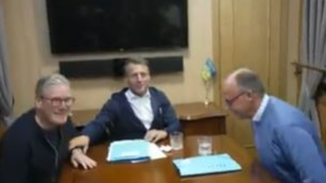 The white object was seen on the table as the trio posed for photos. Picture: X/AFP