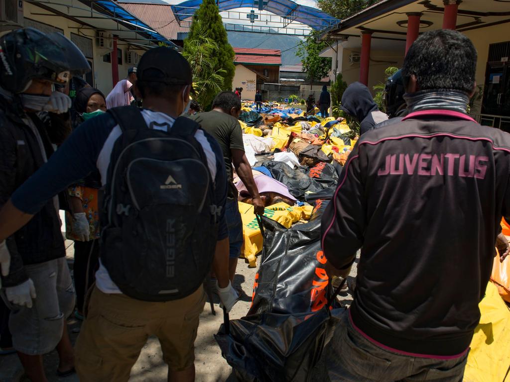 Bodies lined the streets after a tsunami and earthquake struck Indonesia. Picture: AFP