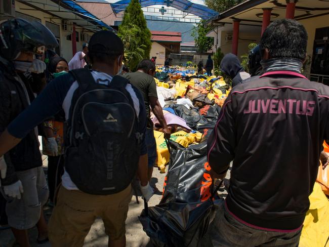 Bodies lined the streets after a tsunami and earthquake struck Indonesia. Picture: AFP