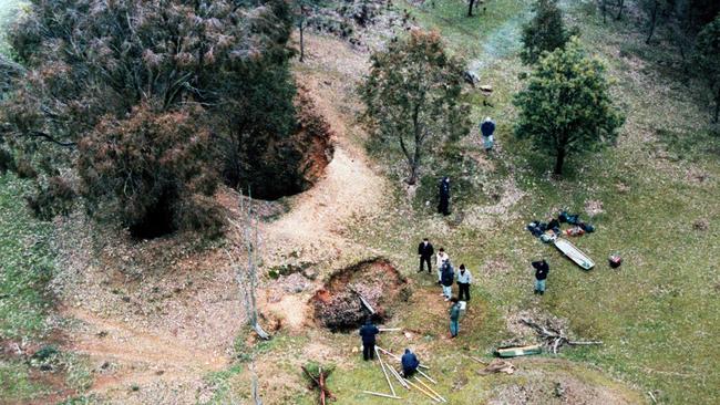 Police inspect the mine shaft where the body of Adele Bailey was found.