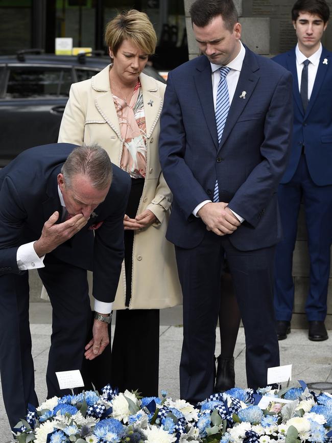 Andrew Prestney lays a wreath with his wife Belinda and son Alex.