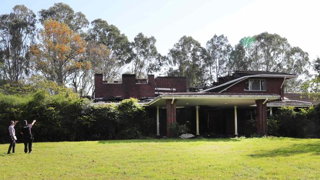 Police investigate at the burnt out remains of the Late Arthur Earle's mansion at Nerang. Picture: Glenn Hampson