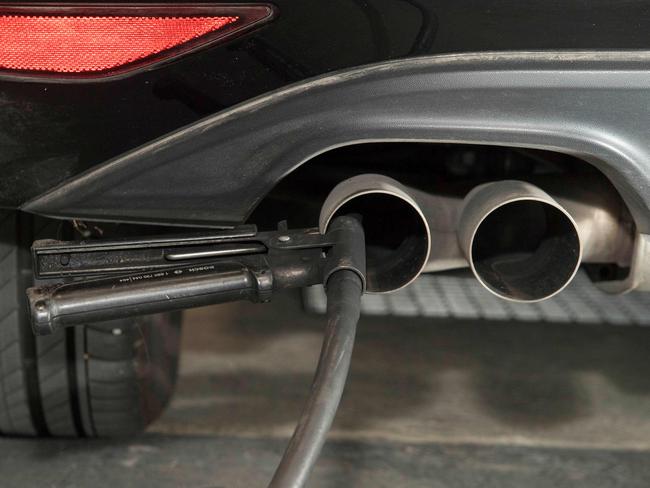 A hose for an emission test is fixed in the exhaust pipe of a Volkswagen Golf 2.0 litre diesel car at the Technical Inspection Agency in Ludwigsburg, southwestern Germany. Picture: Thomas Kienzle