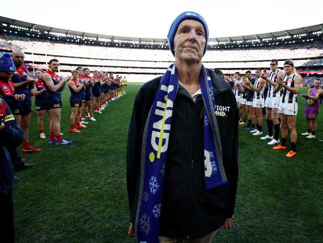 Neale Daniher walks through a guard of honour made up by players of both teams before the round 13 AFL match between Melbourne and Collingwood at the MCG on June 12, 2023. Picture: Michael Klein.