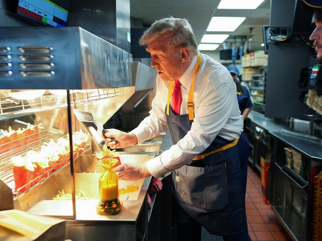 FEASTERVILLE-TREVOSE, PENNSYLVANIA - OCTOBER 20: Republican presidential nominee, former U.S. President Donald Trump works behind the counter making french fries during a visit to McDonald's restaurant on October 20, 2024 in Feasterville-Trevose, Pennsylvania. Trump is campaigning the entire day in the state of Pennsylvania. Trump and Democratic presidential nominee Vice President Kamala Harris continue to campaign in battleground swing states ahead of the November 5th election. (Photo by Doug Mills-Pool/Getty Images)