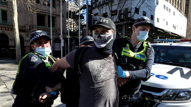 A man is arrested by members of Victoria Police as anti-lockdown protesters take to the streets on August 21 in Melbourne. Picture: Getty