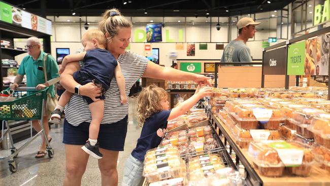 Harlyn Mills, 4, helps her mother Naomie Mills and Jai Mills, 2, pick out treats in the fresh bakery section. Picture: Brendan Radke