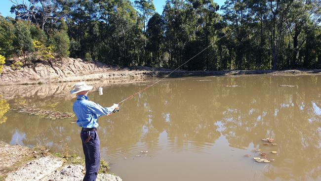 A Natural Resources Access Regulator officer casts a depth sounder which determines the maximum depth of a dam.