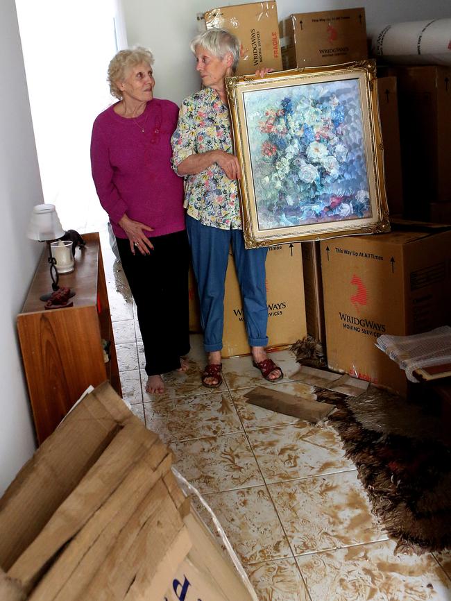 Sisters Johanna Eggers and Huberta Puyverman with Ms Puyverman’s belongings, which were destroyed when their home flooded.