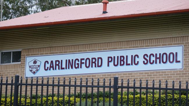 An Education Department official stood at the boy’s school gate with principal Neil Hinton as children went home yesterday. Picture: David Swift