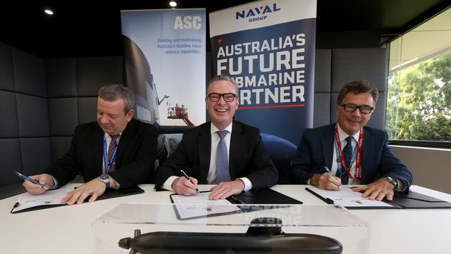 Naval Group Australia CEO John Davies, Minister for Defence Christopher Pyne and ASC CEO Stuart Whiley sign a working agreement between Naval Group and ASC in Adelaide. Picture: AAP / Kelly Barnes