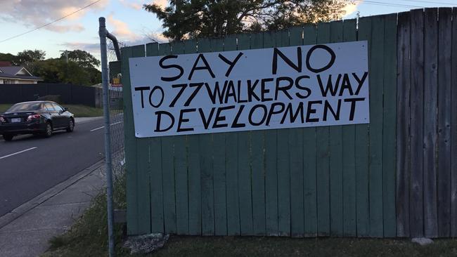 A group of Nundah residents have put up signs protesting against a proposed townhouse development at 77 Walkers Way.