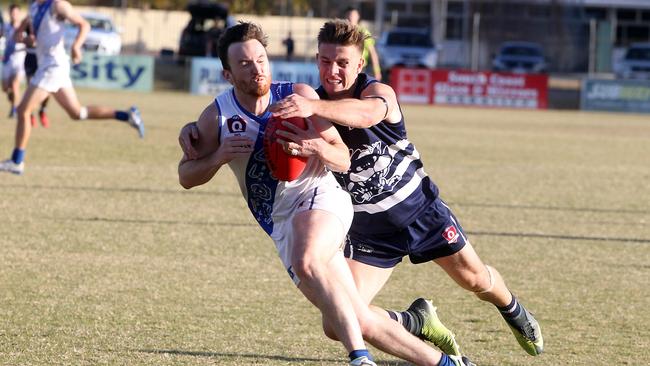 2019 Elimination final of the QAFL Aussie rules competition at Subaru Oval. Broadbeach (blue) v Mt Gravatt. Photo of Benji Neal (cats) and Christopher Murphy.