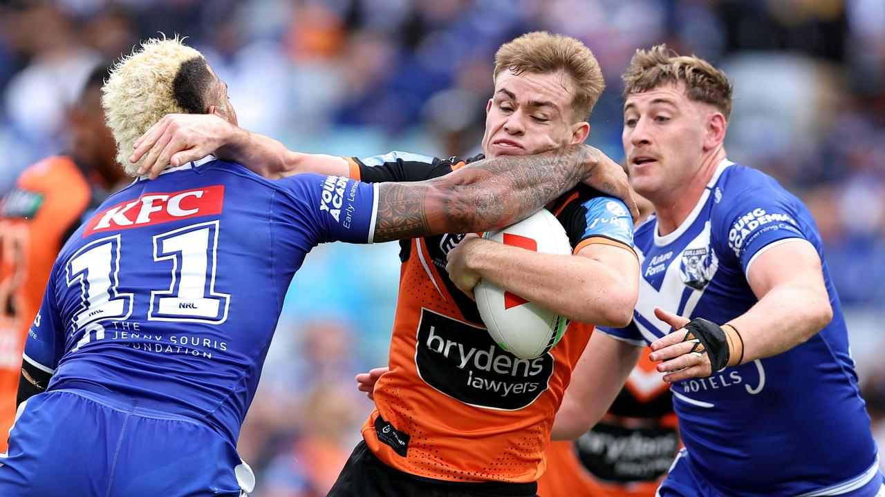 SYDNEY, AUSTRALIA – MAY 04: Lachlan Galvin of the Tigers is tackled by Viliame Kikau of the Bulldogs during the round nine NRL match between Canterbury Bulldogs and Wests Tigers at Accor Stadium, on May 04, 2024, in Sydney, Australia. (Photo by Brendon Thorne/Getty Images)