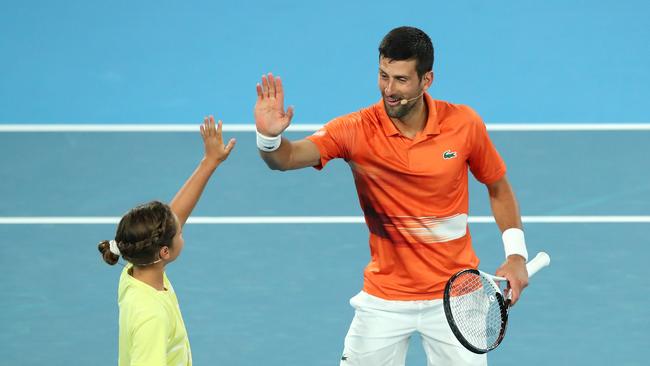 Novak Djokovic celebrates winning a point alongside 10-year-old Ana Maric. Picture: Getty