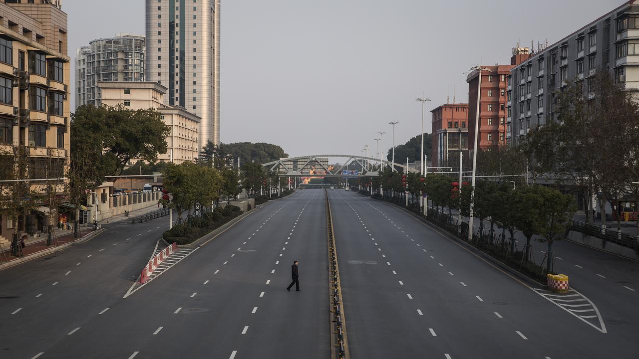 A man cross an empty highway road on February 3, 2020 in Wuhan, Hubei province, China. Picture: Getty Images