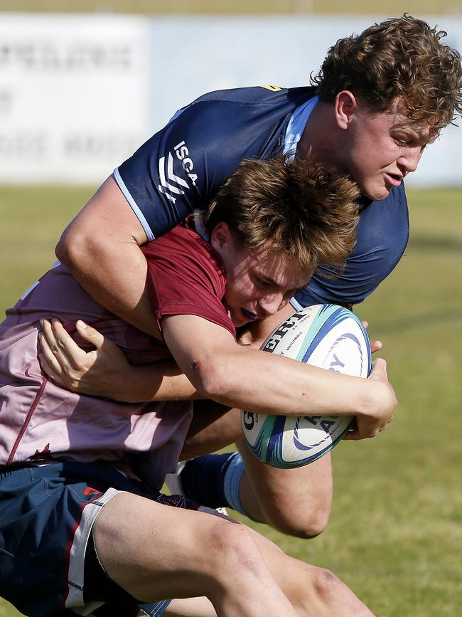 Waratahs' Tom Klem tackles Qld Reds' Jacob Johnson. Picture: John Appleyard