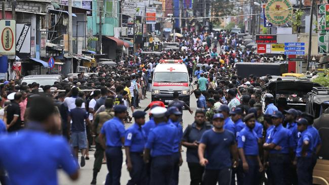 Police clear the road for an ambulance carrying the wounded through the capital yesterday. Picture: AP